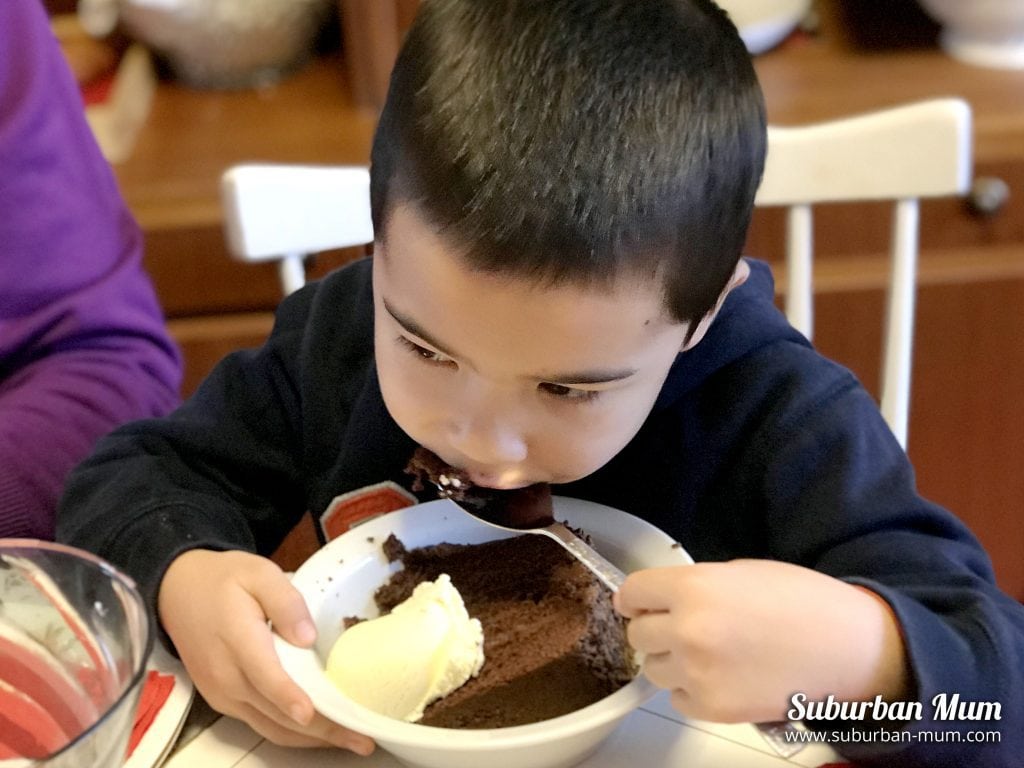 Eating huge slices of chocolate cake