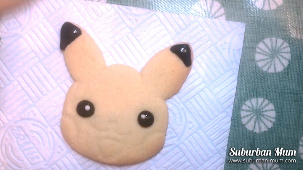 adding the whites of the eyes onto the pikachu cookie