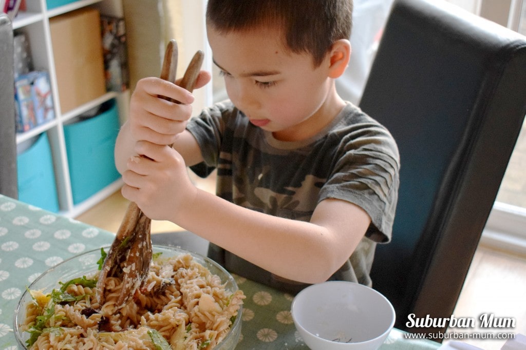 M mixing pasta salad